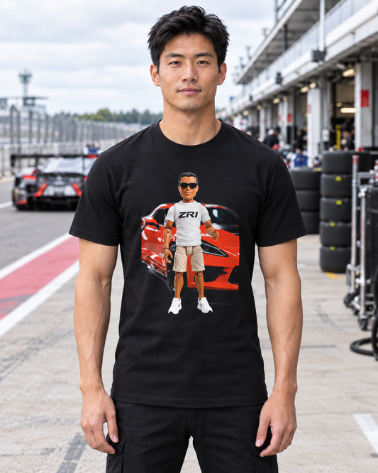 Man in a white Tread & Torque tee with the Lil' Z Corvette ZR1 graphic, holding coffee at an early morning Corvette car meet